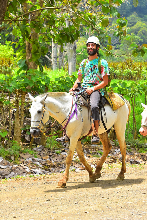 Man on horseback in a Costa Rican outdoor setting.