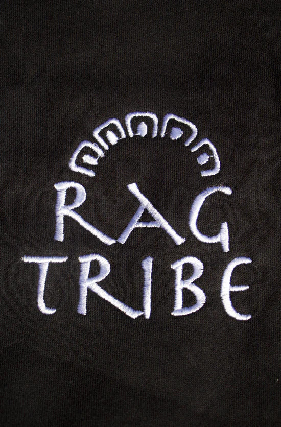Embroidered 'Räg Tribe' logo on a black background